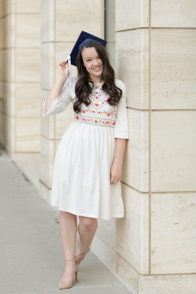 BYU graduate woman smiles in her cap during her BYU senior portraits