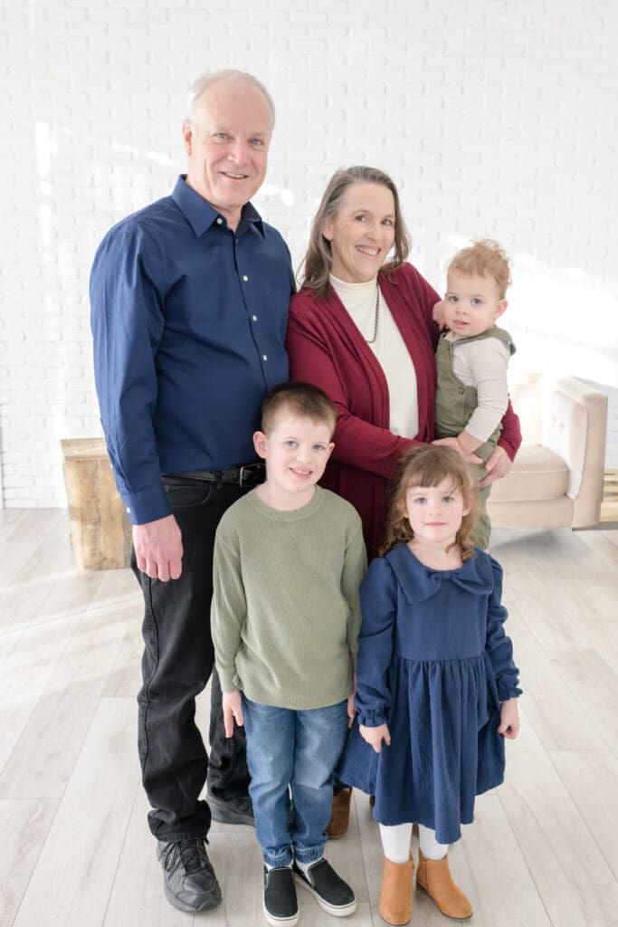 Grandparents with their three grandchildren during a cozy studio extended family session with Jodi Cornwall Photography