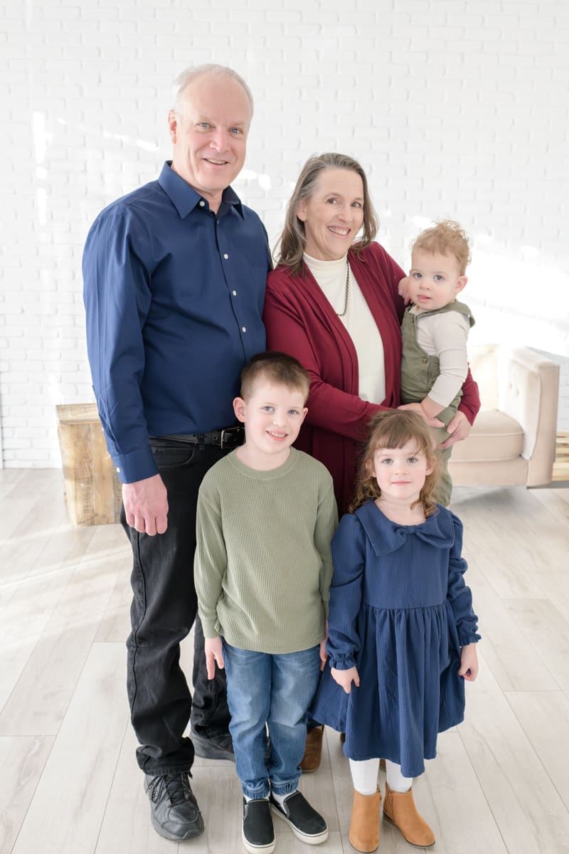 Grandparents with their three grandchildren during a cozy studio extended family session with Jodi Cornwall Photography