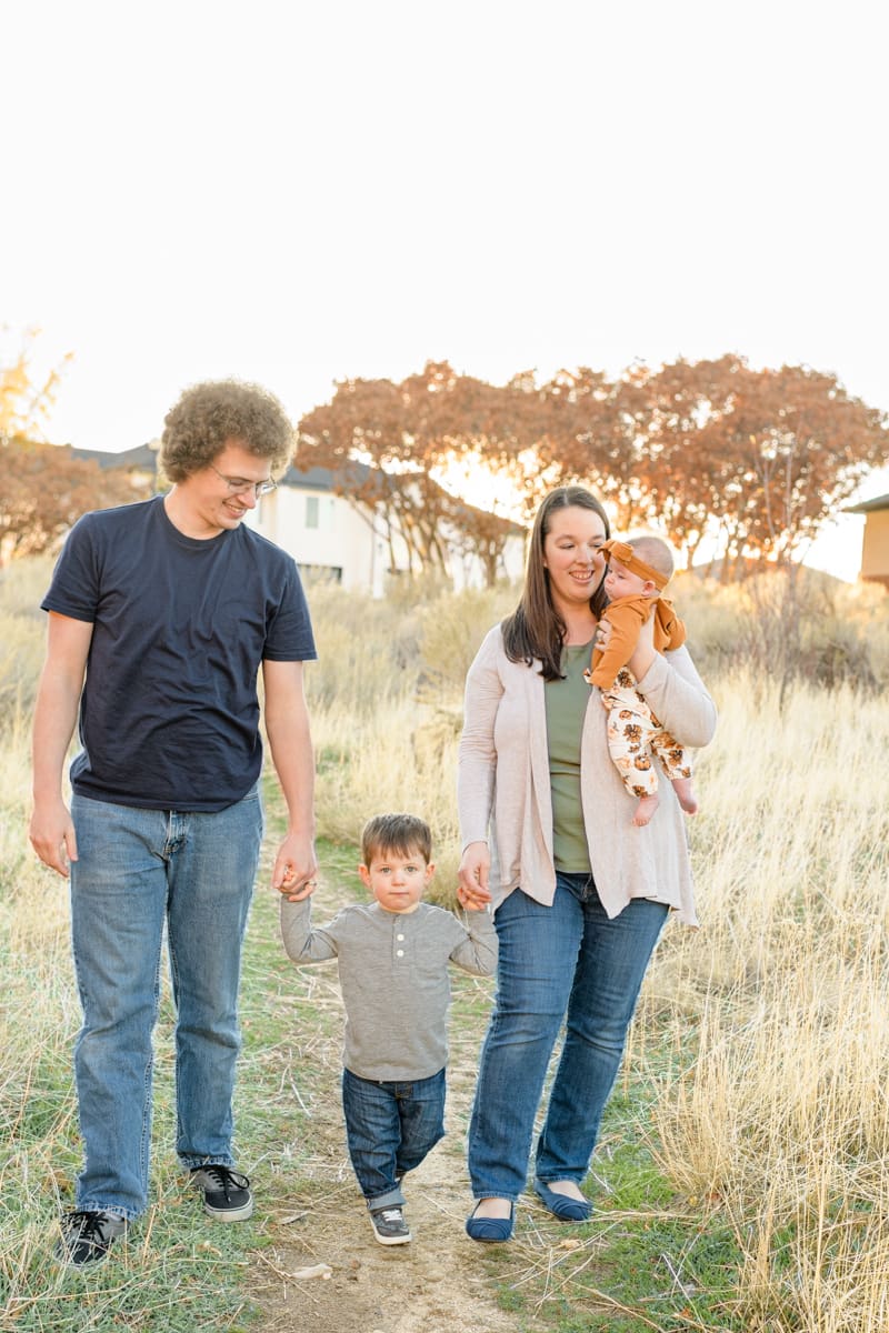 Family walks through fall trail