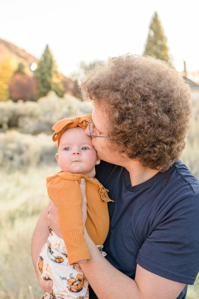 Dad kisses baby