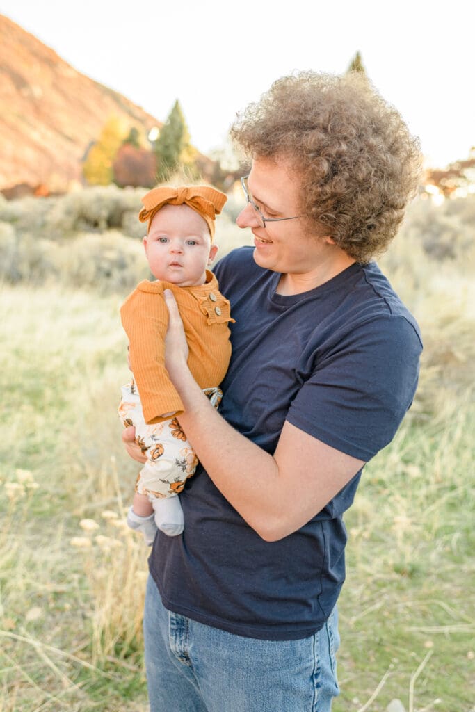 Dad smiles at baby daughter