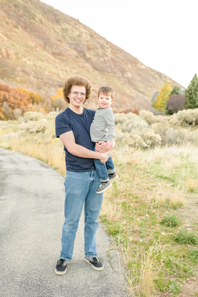 Dad holds his toddler son