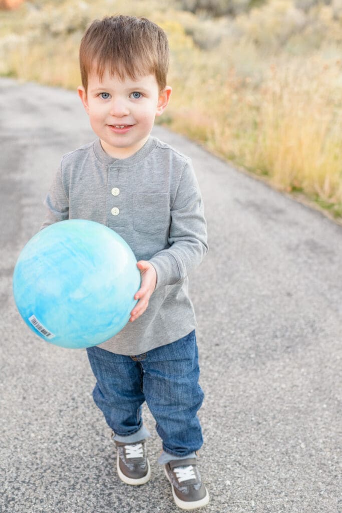 Little boy holds ball