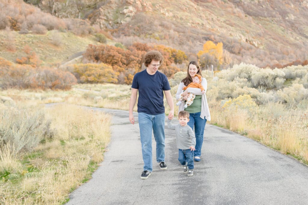 Family walks through fall trail