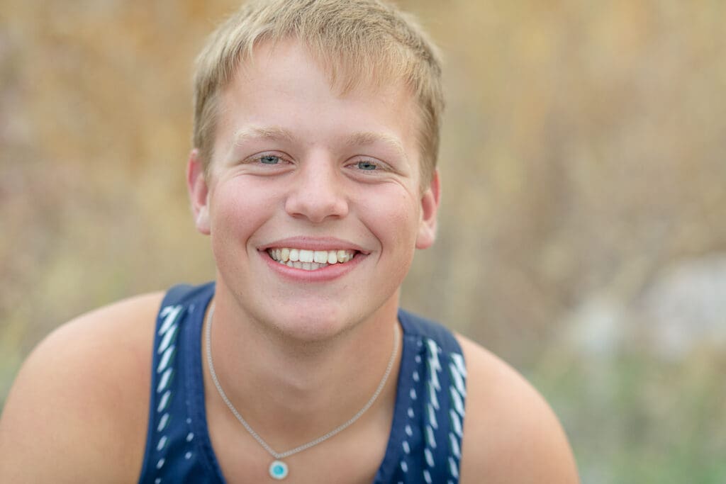 High school senior athlete boy smiling in the fall