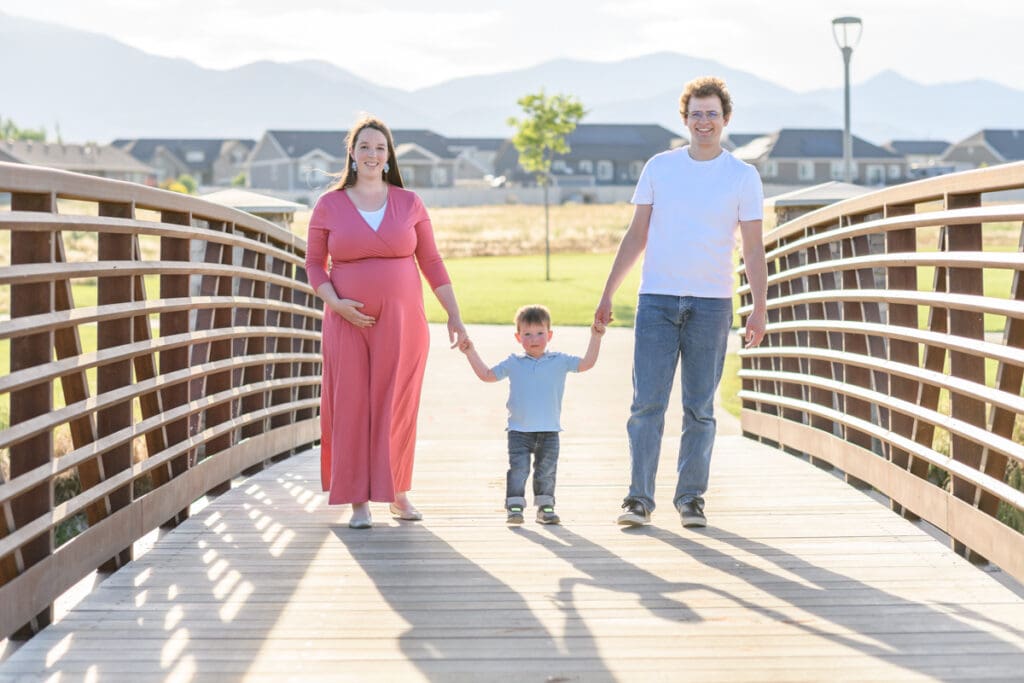 Young family walking on a bridge
