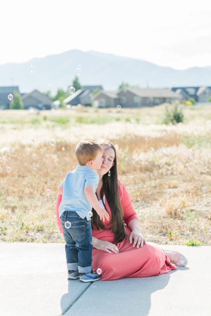 Toddler kissing his mom