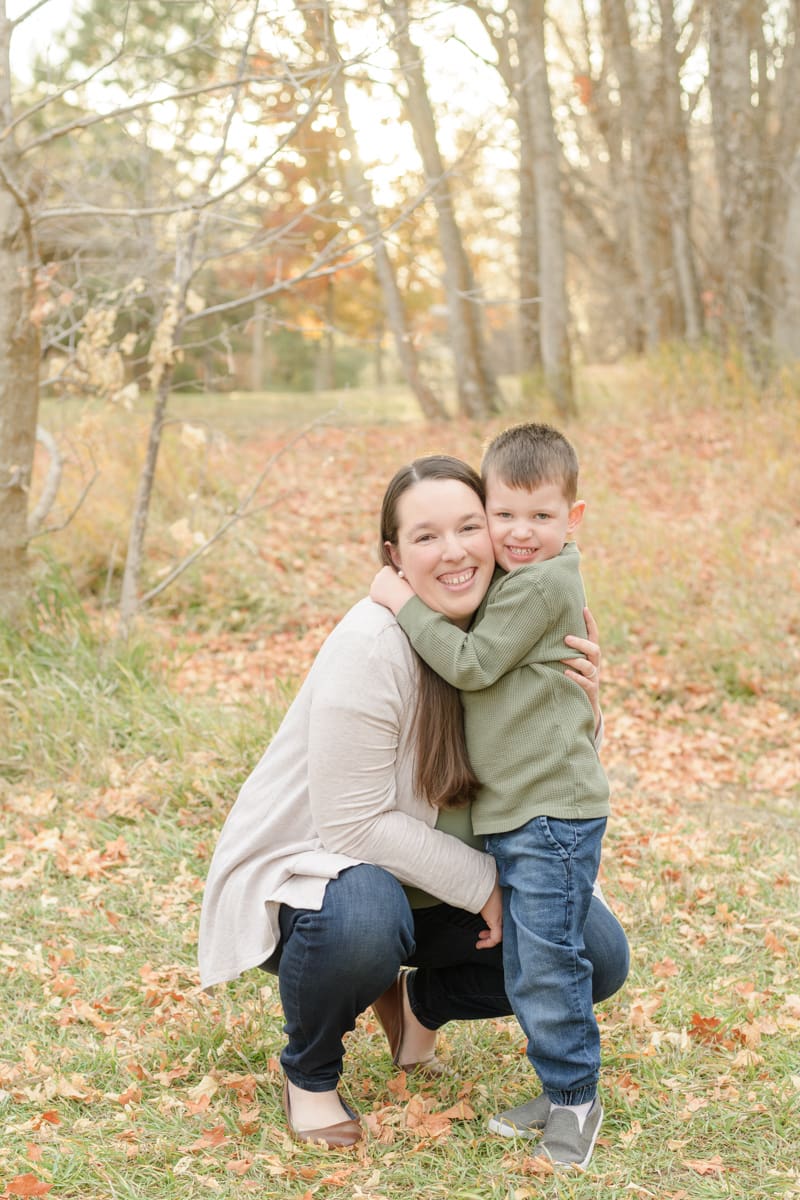 Mom and son hugging in fall leaves. Canyon Fall family Session