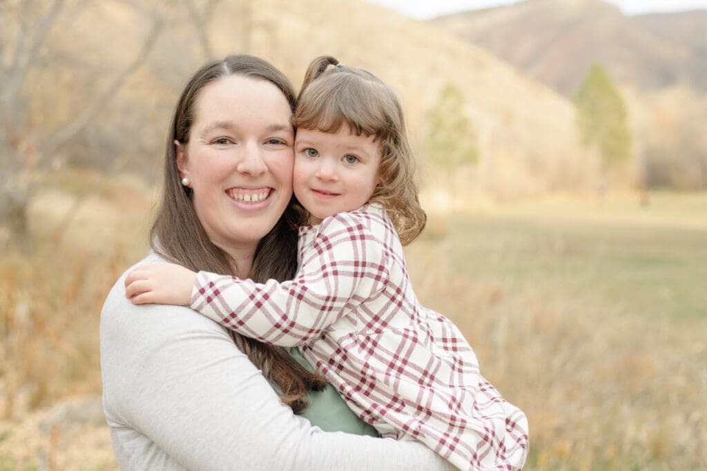 Mom and young daughter smiling in fall. Canyon Fall family Session