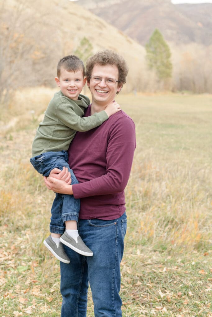 Dad and young son smiling in fall. Canyon Fall family Session