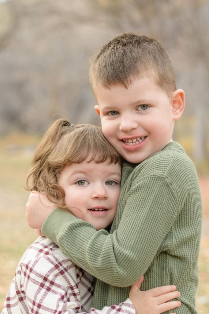 Little kids hugging in fall. Canyon Fall family Session