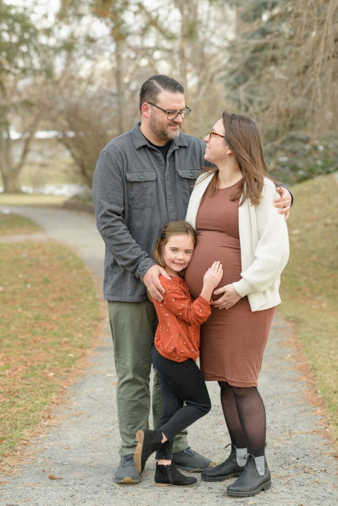 Family smiling in a wooded park