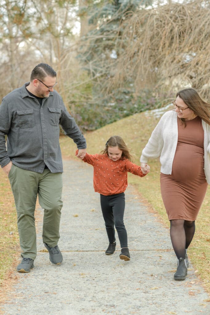 Family walking together in a park for maternity photoshoot