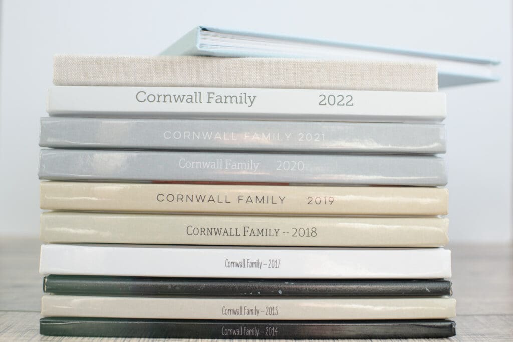 A stack of photo books sharing how to take, organize, and print photo memories.