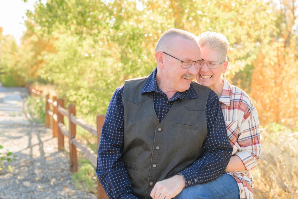 Playful moment during couples photography with teasing smiles.