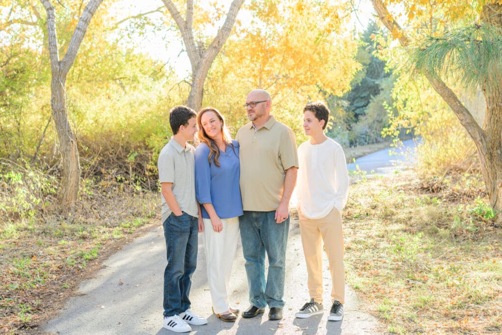 Family laughing together surrounded by fall colors