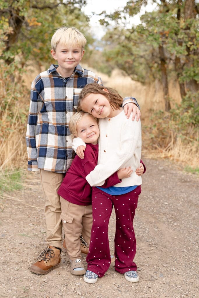 Children snuggling close during family photos.