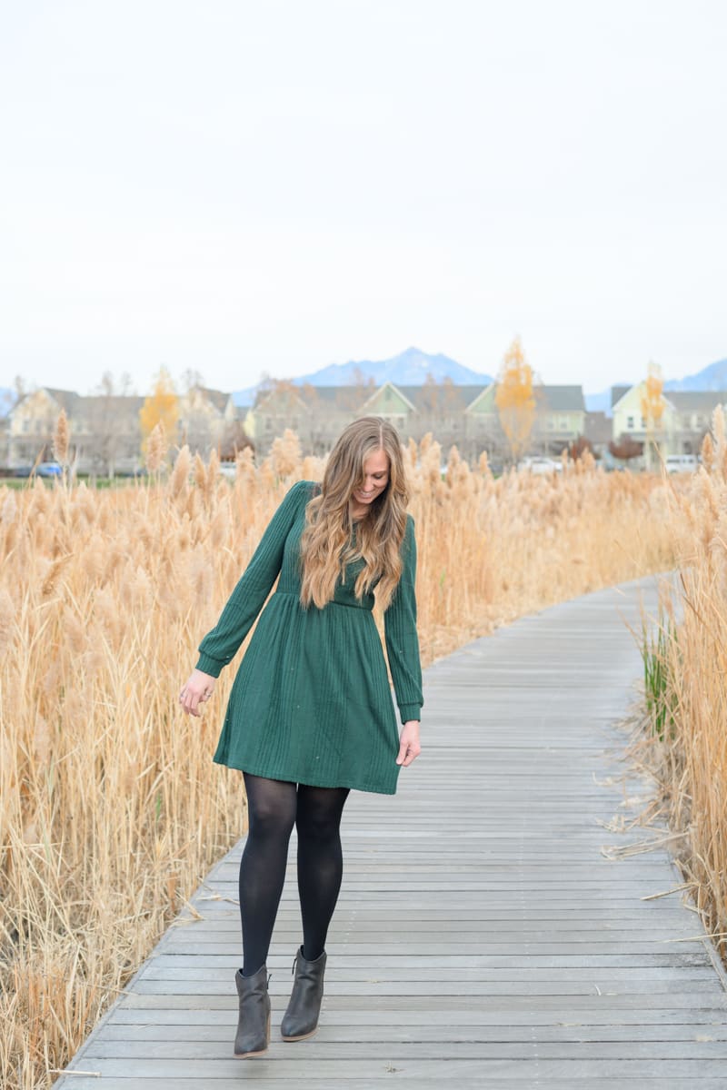 A woman walks along the Daybreak boardwalk during a relaxed portrait session