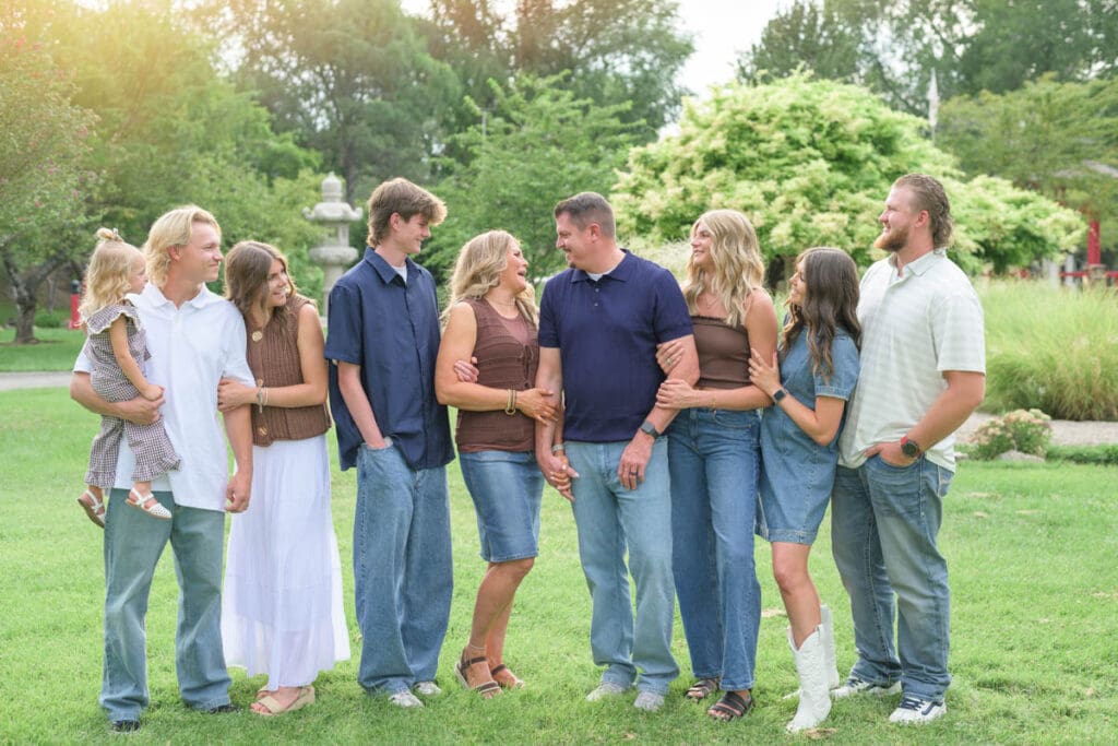 A family laughs with each other during an extended family photography session.