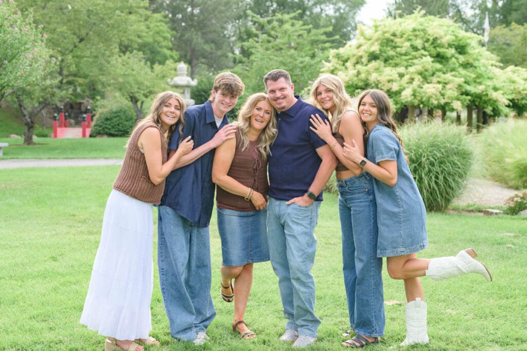 A family laughs and holds each other close during an extended family photography session.